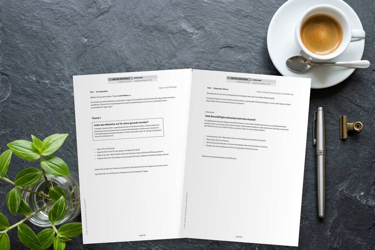 Goethe-Zertifikat C1 speaking sheets with a talk topic and a discussion task lying on a desk